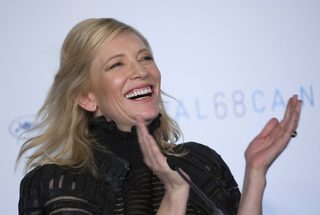 Cast member Cate Blanchett applauds as she attends a news conference for the film "Carol" in competition at the 68th Cannes Film Festival in Cannes