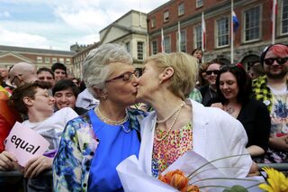 Same-sex marriage supporters kiss at Dublin Castle in Dublin