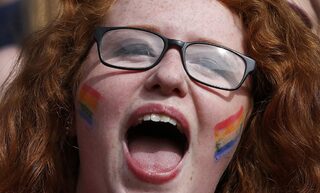 A same-sex marriage supporter reacts at Dublin Castle in Dublin