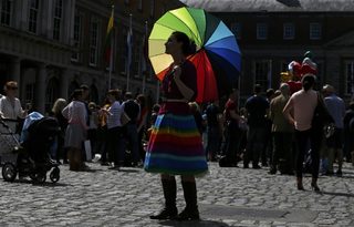 A same-sex marriage supporter poses for a photograph at Dublin Castle in Dublin