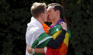 A couple embraces outside the count centre in Dublin as Ireland holds a referendum on gay marriage