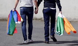 A couple walks hand in hand from the count centre in Dublin as Ireland holds a referendum on gay marriage