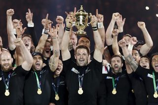 Captain McCaw of New Zealand holds up the Webb Ellis Cup after winning the Rugby World Cup Final against Australia at Twickenham in London