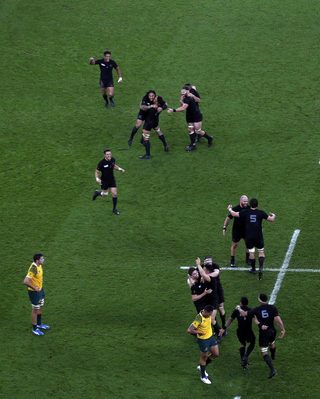 New Zealand's players celebrate after winning their Rugby World Cup Final against Australia at Twickenham in London