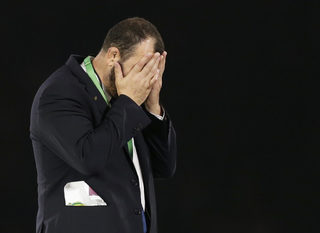 Michael Cheika, head coach Australia walks away after receiving his runners-up medal from Prince Harry after the Rugby World Cup final match against New Zealand at Twickenham in London