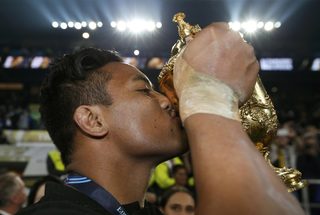 Julian Savea of New Zealand kisses the Webb Ellis Cup as he celebrates after beating Australia to win the Rugby World Cup final match at Twickenham in London