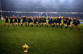 New Zealand's team performs the haka with the Webb Ellis trophy as they celebrate after winning the Rugby World Cup Final against Australia at Twickenham in London