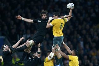 Whitelock of New Zealand and Simmons of Australia are lifted by team mates as they jump for the ball during their Rugby World Cup Final at Twickenham in London