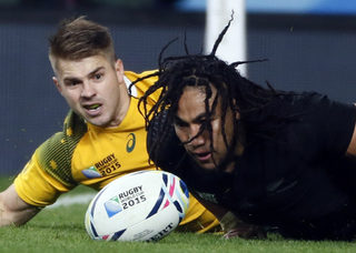 Nonu of New Zealand scores a try past Mitchell of Australia during their Rugby World Cup Final at Twickenham in London