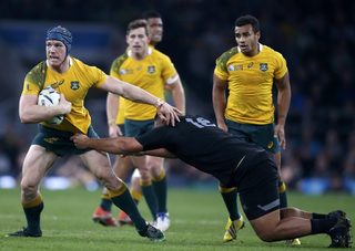 David Pocock of Australia is tackled by Keven Mealamu of New Zealand during their Rugby World Cup final match at Twickenham in London