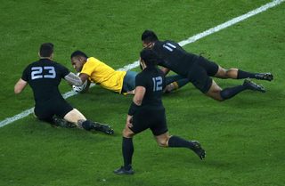 Kuridrani of Australia scores a try between Williams, Nonu and Savea of New Zealand during their Rugby World Cup Final at Twickenham in London