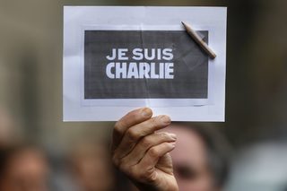 A person holds a placard with a pencil which reads "I am Charlie" during a minute of silence in Strasbourg for victims of the shooting at the Paris offices of weekly satirical newspaper Charlie Hebdo on Wednesday