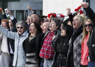 Relatives sing "You'll never walk alone" after the jury delivered its verdict at the new inquests into the Hillsborough disaster, in Warrington, Britain