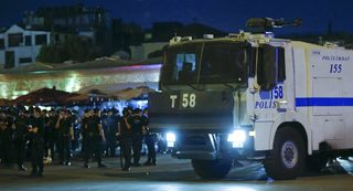 Turkish police officers stand by a car near the Taksim Square in Istanbul