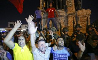 People demonstrate in front of the Republic Monument at the Taksim Square in Istanbul