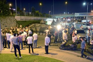 A crowd surrounds Turkish armoured vehicles near Ataturk airport in Istanbul