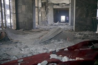 A man walks inside the destroyed parliament building in Ankara