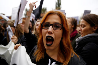 A woman shouts slogans as people gather in an abortion rights campaigners' demonstration to protest against plans for a total ban on abortion in front of the ruling party Law and Justice (PiS) headquarters in Warsaw