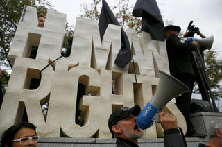People take part in an abortion rights campaigners' demonstration "Black Protest" in front of the Parliament in Warsaw