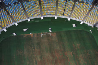 Aerial view of Maracana Stadium shows seats missing and the turf dry, worn and filled with ruts and holes in Rio de Janeiro