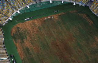 Aerial view of Maracana Stadium shows seats missing and the turf dry, worn and filled with ruts and holes in Rio de Janeiro