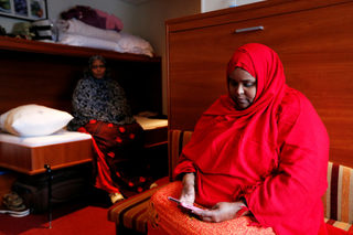 Women from Somalia pose in a cabin of a floating hotel in Groningen