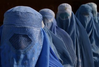 Afghan widows line up at food distribution centre run by CARE international in Kabul