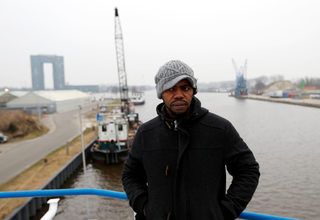 Sall from Guinea poses on a floating hotel in Groningen