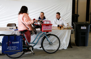 A cyclist votes in the Dutch general election in a drive-in polling station in Zuidplas