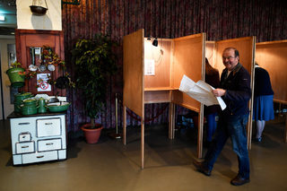 People vote during the general election at a poling station inside a bar in Kinderdijk