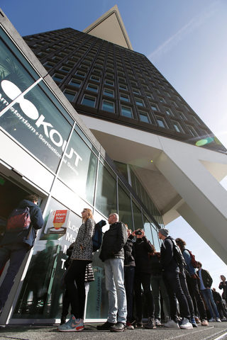 People queue as they wait to vote during the general election at a polling station inside the ADAM Tower in Amsterdam North