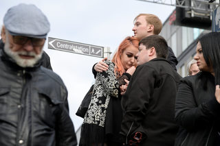 A young woman, an evacuee from the central train station, reacts after people were killed when a truck crashed into a department store, Ahlens, in central Stockholm