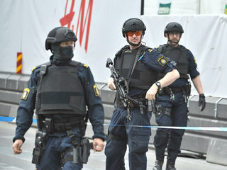 Policemen guard the street after people were killed when a truck crashed into a department store Ahlen, in central Stockholm