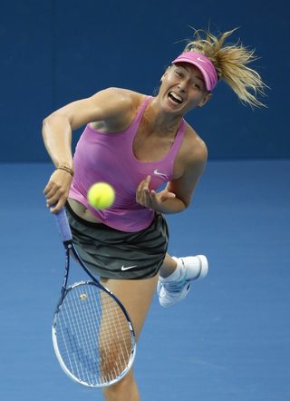 Sharapova of Russia serves against Kanepi of Estonia during their women's singles match at the Brisbane International tennis tournament in Brisbane