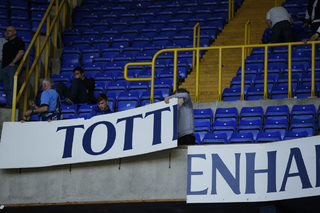 Tottenham fans pull of the boards during the ceremony after the game
