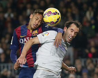 Barcelona's Neymar fights for the ball against Atletico Madrid's Diego Godin during their Spanish First division soccer match at Camp Nou stadium in Barcelona