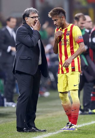 Barcelona's coach Martino gives instructions to his player Neymar during their Champions League soccer match against AC Milan in Milan