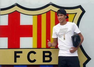 Brazilian soccer player Neymar poses for the media in front of Barcelona's offices, close to Camp Nou stadium in Barcelona