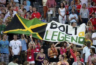 Supporters of Usain Bolt of Jamaica hold a flag during the world athletics championships at the Olympic stadium in Berlin