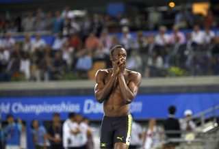 Usain Bolt of Jamaica walks without his shirt after being disqualified for a false start during the men's 100 metres final in Daegu