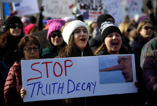 2018-01-20T221213Z_1317463891_RC1BBBDD7500_RTRMADP_3_USA-TRUMP-WOMEN.JPG