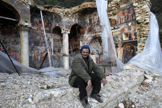 A man looks at the camera in The Orthodox Church of Saint Athanasios in Leshnica