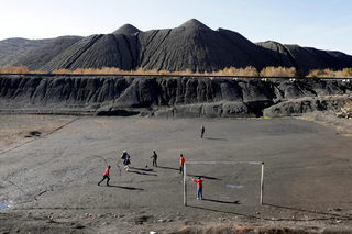 Children play football at what used to be a coal mine in Jerada
