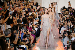 Models present creations by designer Elie Saab as part of his Haute Couture Fall/Winter 2018/2019 fashion show in Paris