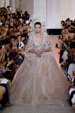 A model presents a wedding dress by designer Elie Saab as part of his Haute Couture Fall/Winter 2018/2019 fashion show in Paris