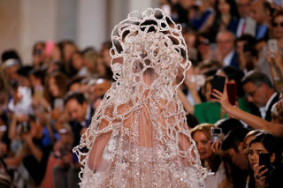 A model presents a wedding dress by designer Elie Saab as part of his Haute Couture Fall/Winter 2018/2019 fashion show in Paris