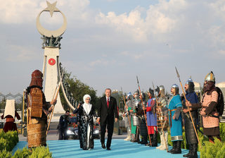 Turkish President Tayyip Erdogan, accompanied by his wife Emine Erdogan, arrives for a ceremony at the Presidential Palace in Ankara