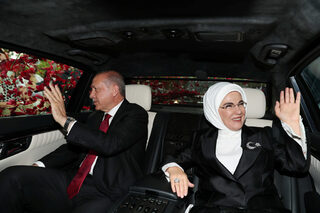 Turkish President Tayyip Erdogan, accompanied by his wife Emine Erdogan, greets his supporters as he drives to the parliament to take the oath of office for a new presidential term, in Ankara