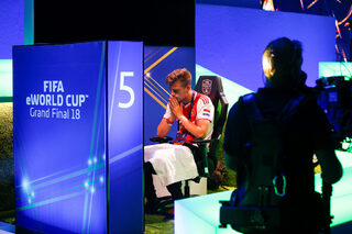Professional Xbox player Dani, real name Dani Hagebeuk, reacts while playing in the group stages of the FIFA eWorld Grand Final at the O2 Arena in London