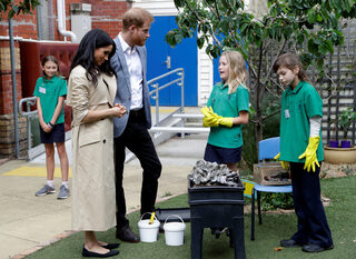 Britain's Prince Harry and Meghan, Duchess of Sussex greet children during a visit to Albert Park Primary School in Melbourne